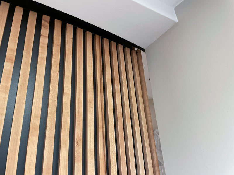 A detailed view of a maple slatted hardwood door.