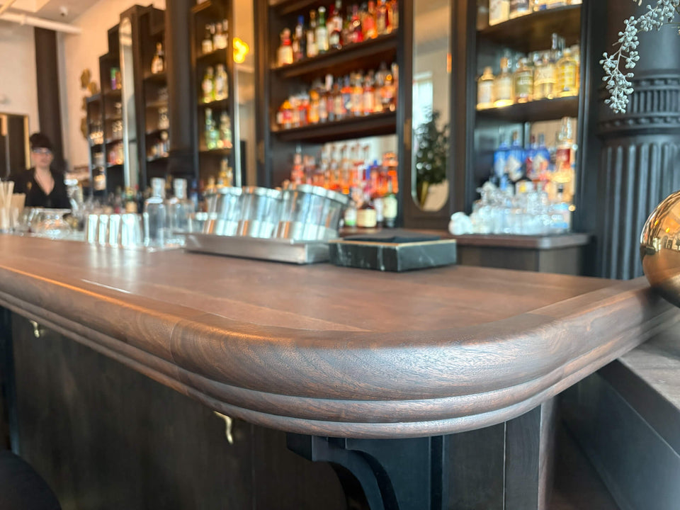 Curved edge of a walnut bar top finished with Rubio Monocoat Oil Plus 2C hardwax oil wood stain and finish.
