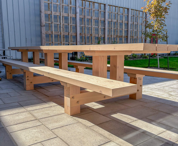 A massive timberframe exterior table with functional joinery crafted from Douglas Fir and finished with Rubio Monocoat DuroGrit exterior wood stain and sealer.