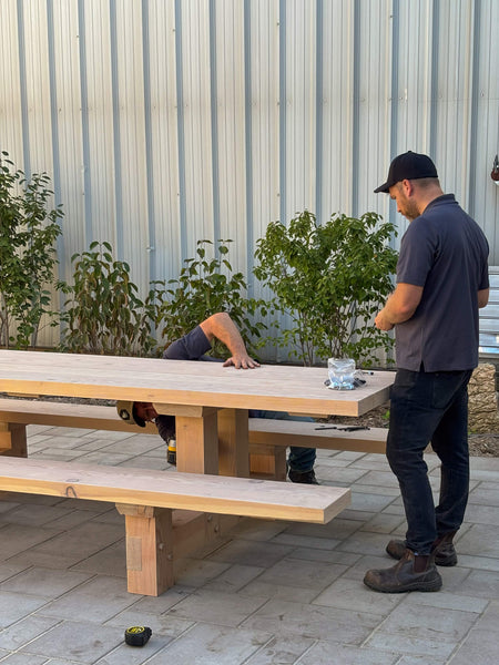 Installing the table top boards on a timberframe picnic table finished with DuroGrit.