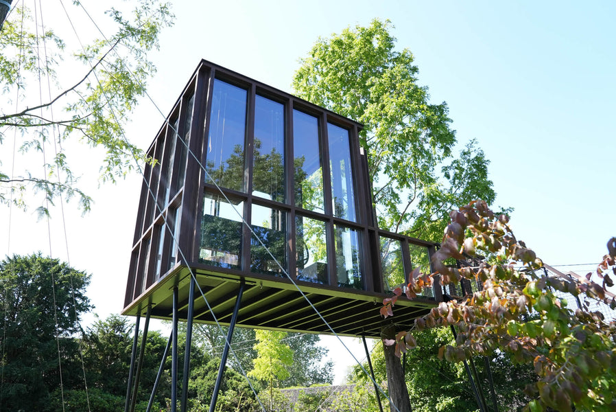 A modern tree house made from wood and many windows finished using Rubio Monocoat DuroGrit.