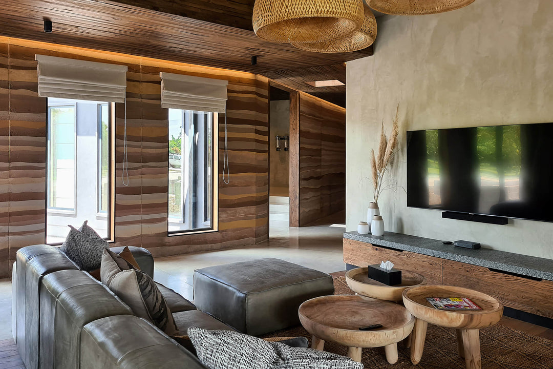 Living room in a safari-inspired home with European oak paneling on the ceiling and media storage finished with Oil Plus 2C "Black".