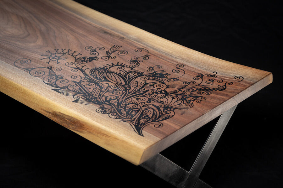 A beautiful intricate design carved in a live edge walnut coffee table.