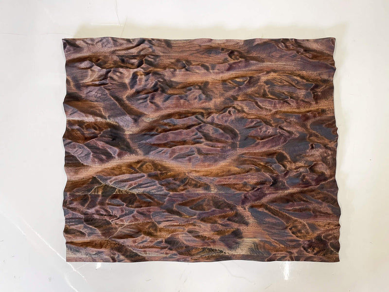 A topographic map of the Canadian Rocky Mountains made out of walnut and finished with Oil Plus 2C.