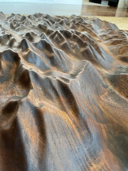 Detail shot of a walnut topographic map finished with a hardwax oil wood finish.