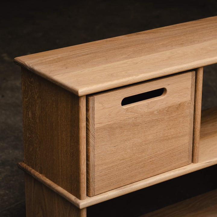 Close-up detail of a white oak bookcase corner joint and cutout handle storage cube, showcasing natural wood grain with Rubio Monocoat Oil Plus 2C Dunes finish.