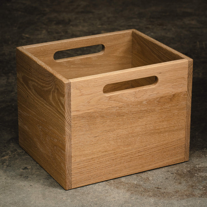 Standalone white oak storage cube with cutout handles, handcrafted and finished with Rubio Monocoat Oil Plus 2C Dunes hardwax oil.