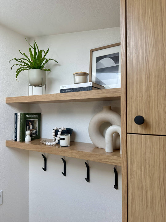 Floating white oak shelving with various decor elements finished with Rubio Monocoat Oil Plus 2C Dunes for interior wood flooring, cabinetry, furniture and more.