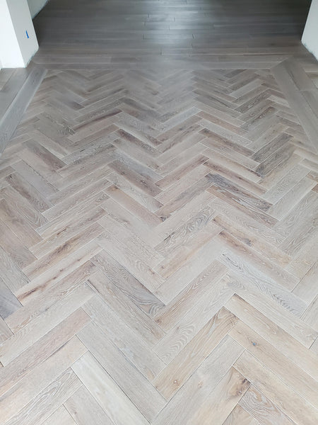 Herringbone white oak wood flooring with plain sawn number 1 grade finished with Rubio Monocoat wood finish products.