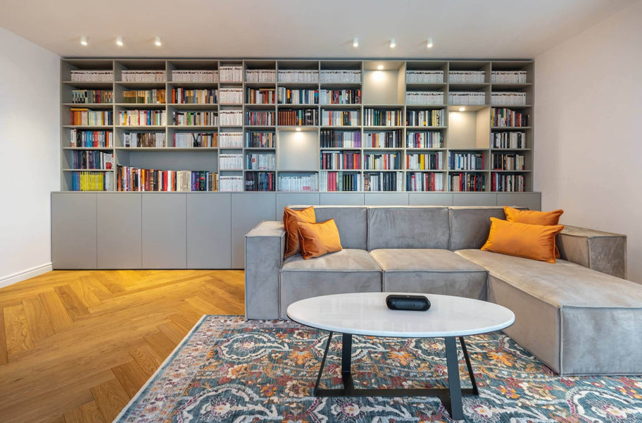 Living room with light colored herringbone floors.