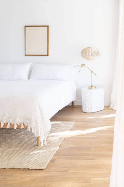Relaxing guest bedroom with natural hardwood flooring