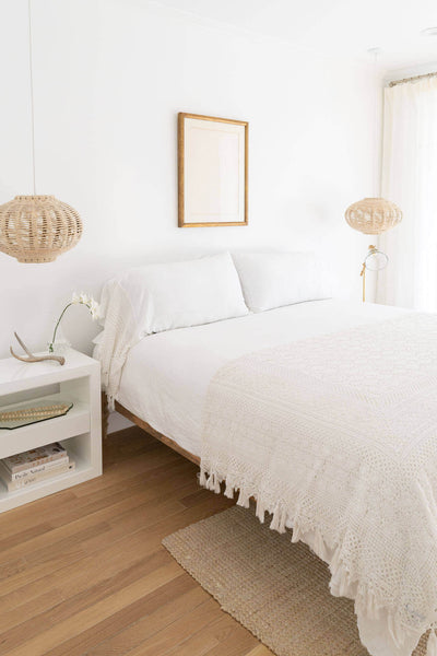Guest bedroom with white decor and wood flooring