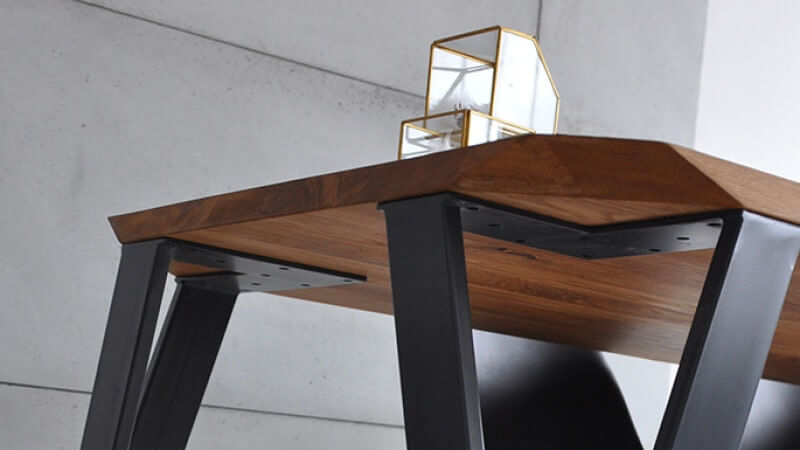Modern wood table with geometric lines and metal legs.