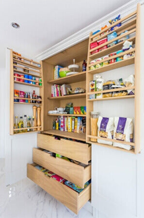 Beautiful pantry cupboard redesign with oak shelving and lots of drawer and shelf space.