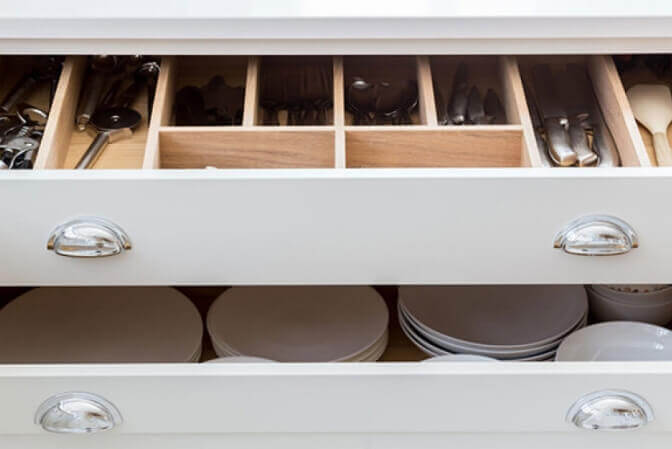 White shaker drawers with silverware organizer.