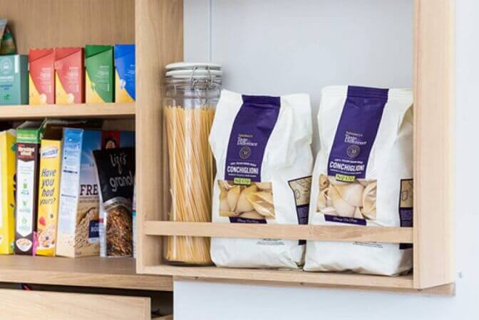 Natural wood shelves in a pantry cupboard.