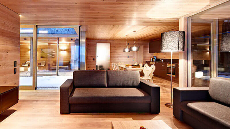 A warm ski resort with oak wood for the flooring, walls, and ceiling.