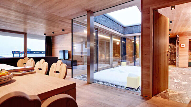 The warm atmospheric interior of a ski lodge featuring wooden walls, floors and ceilings.
