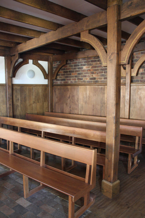 Wooden architectural details and pews in a church.