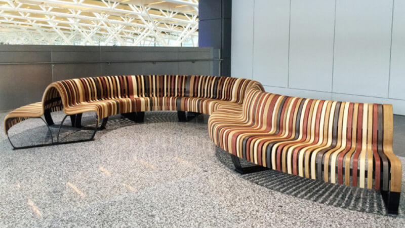 Unique wooden bench in Calgary International Airport finished with Rubio Monocoat hardwax oil.