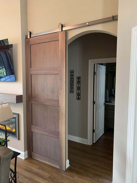 Solid walnut barn door finished with Rubio Monocoat hardwax oil.