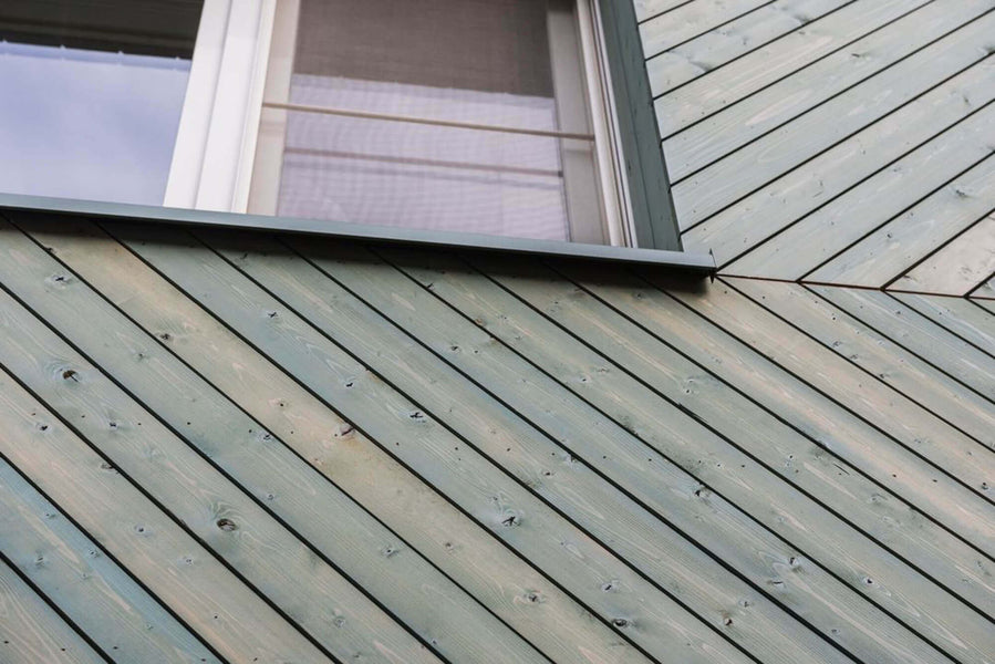 WoodCream Forrest Green was used on this wood siding installed in a chevron pattern.
