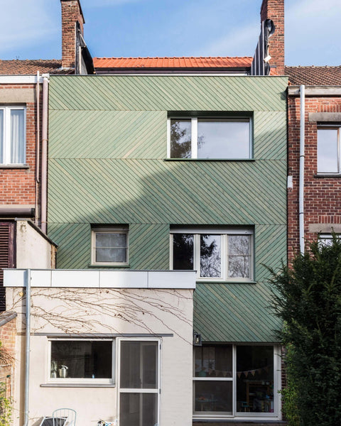 A building with green wood siding finished with Rubio Monocoat exterior wood finish.