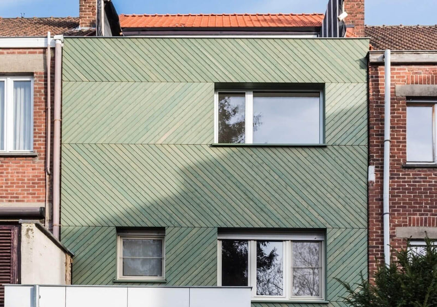Green chevron wood cladding finished with WoodCream, an exterior wood finish.