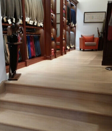 Stairs in a clothing store with Rubio Monocoat Oil Plus 2C in the color natural on them.