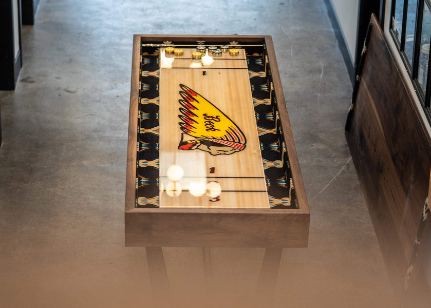 Walnut shuffleboard table complete with the Indian Motors logo.