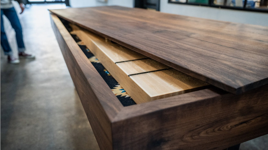 Walnut shuffleboard with lid partially on.