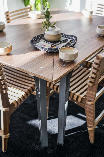 Wood dining table and chairs staged.