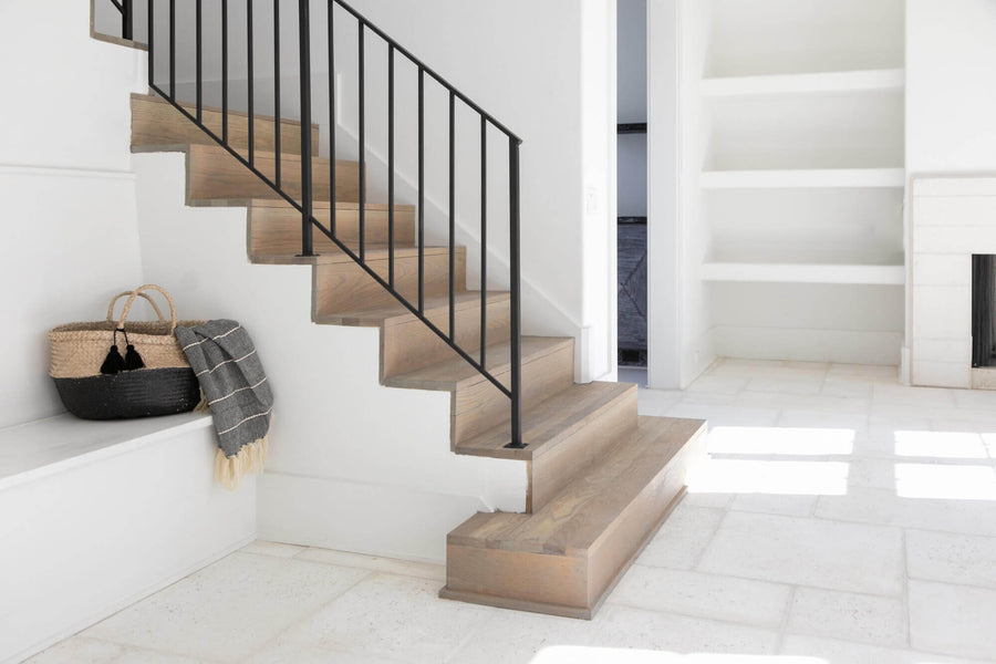 White oak stair treads in a light white living area.