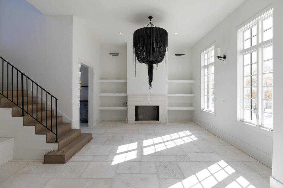 Light living room with grey wood stairs.