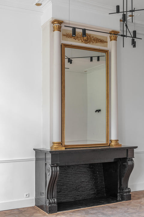 A stone fireplace on in a room with a stunning parquet flooring finish with Rubio Monocoat products.