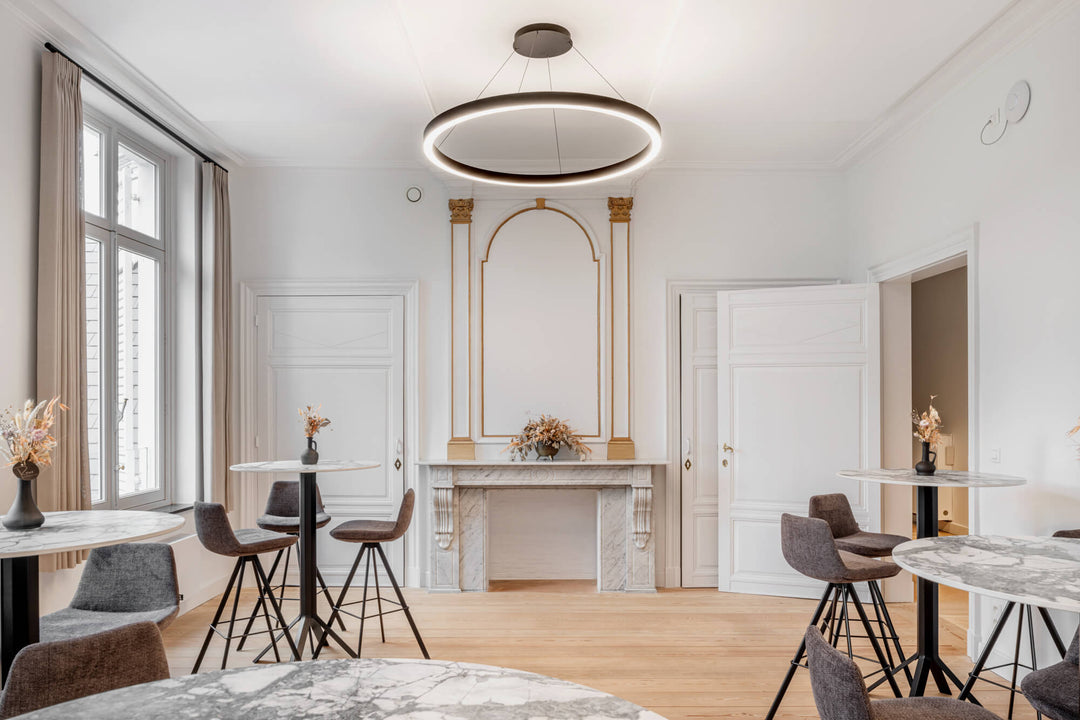 A lovely room with refinished wood flooring and bar height tables. A marble fireplace is the centerpiece of this space.