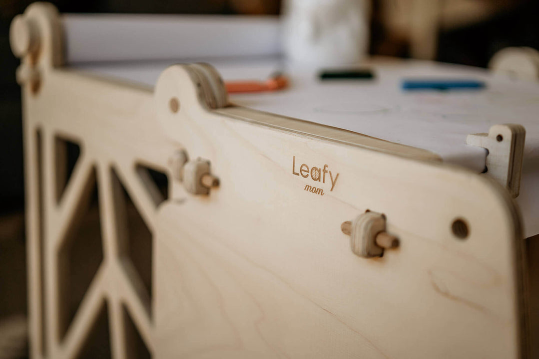 A close up image of the brand, Leafy Mom, which designed and sells this functional, safe toddler learning tower.