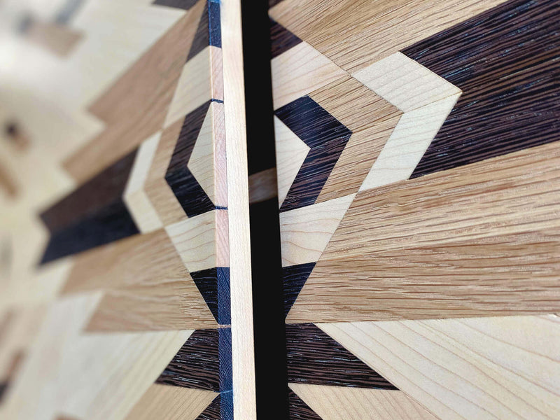 Details of a tribal pattern, made from solid maple, white oak, and wenge.