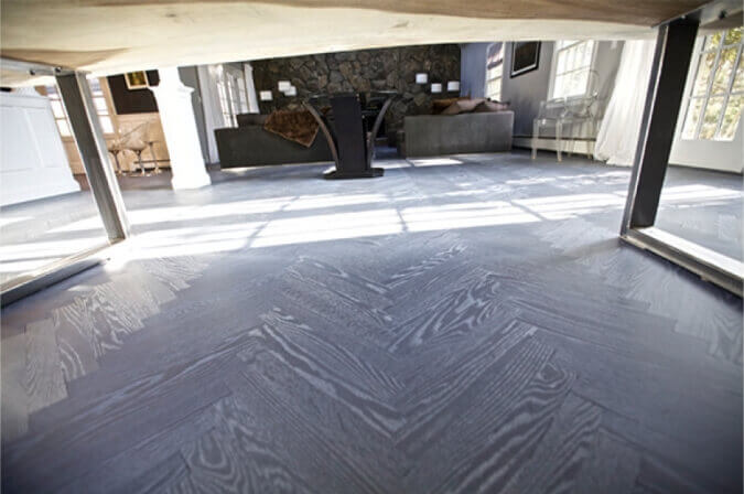 Herringbone hardwood floors finished with stain and hardwax oil.