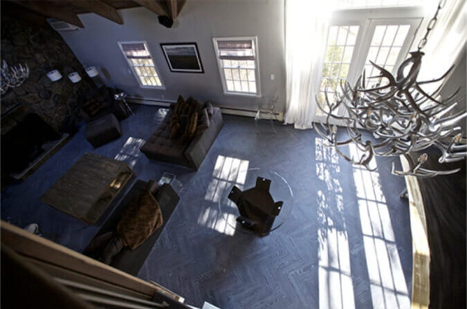 Top-down view of a living area with herringbone wood floors that are fumed and finished with white oil.