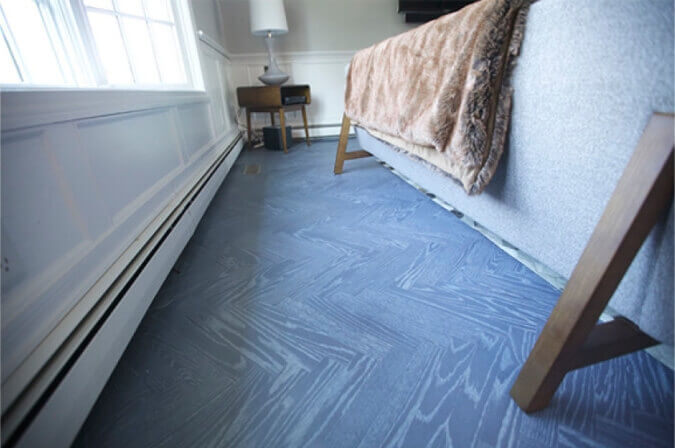 Oak wood flooring in a herringbone pattern behind a cough.