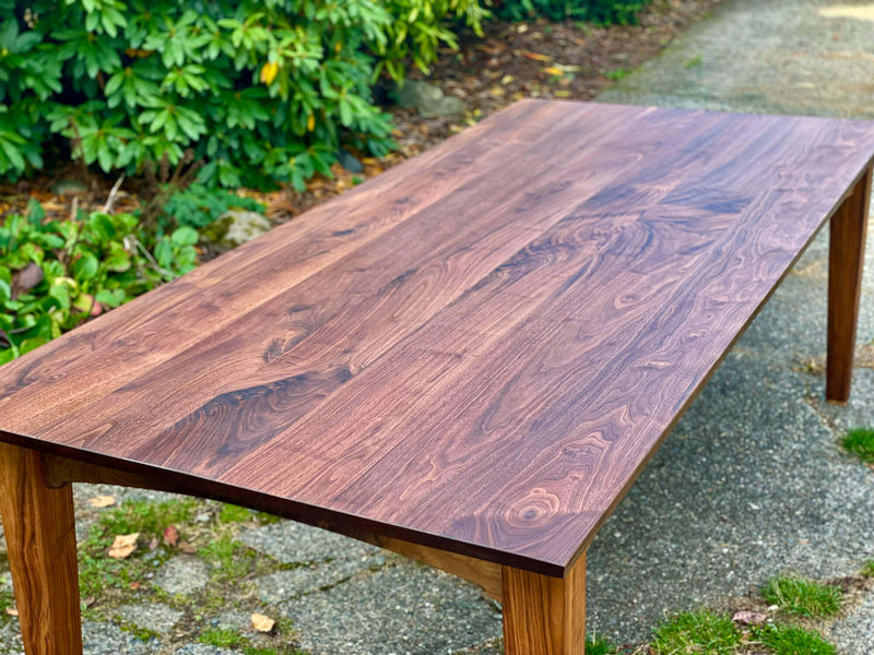 A walnut dining table finished with a wood oil finish.