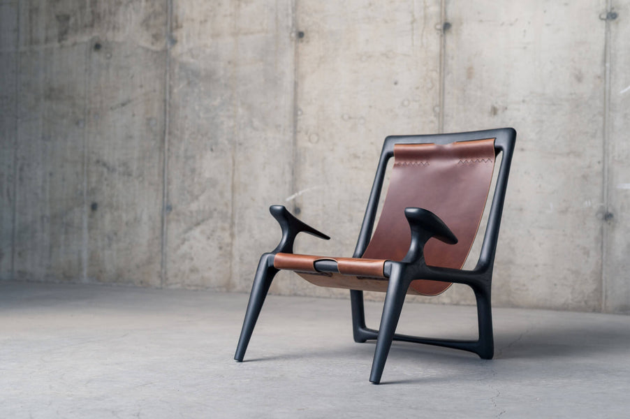 Custom chair made out of leather and wood.