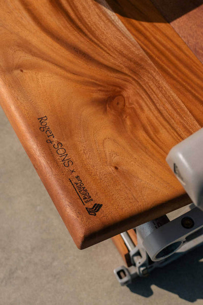 Roger & Sons logo on upcycled airplane seats made from African Mahogany.