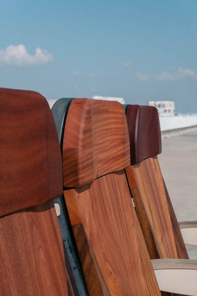 Three upcycled airline seats made from mahogany.