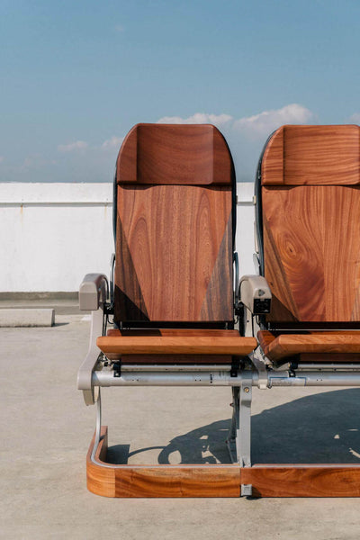Two mahogany upcycled airline seats made from mahogany recycled from Singapore Airlines.