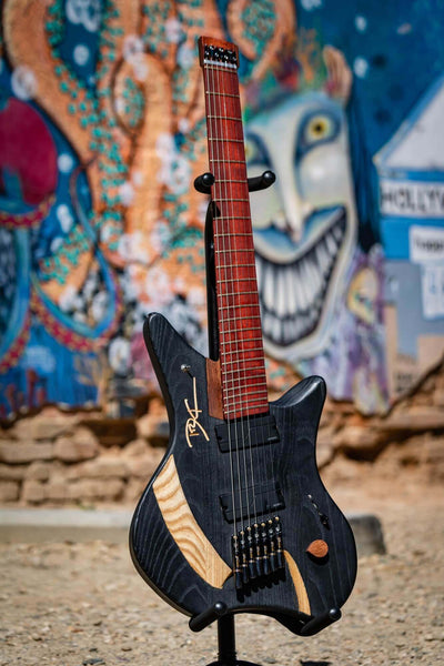 Matte black 7 string guitar body from ash, kekatong, maple and padouk wood.