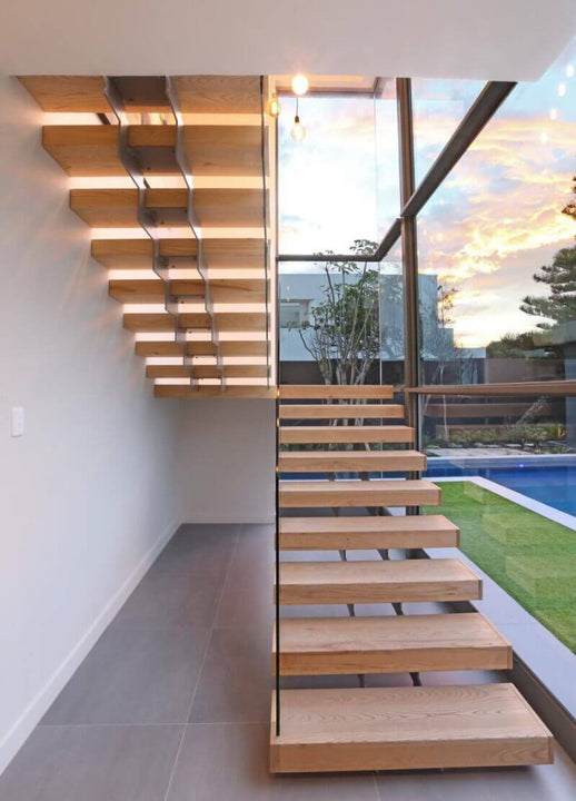A modern staircase with wood steps finished using Oil Plus 2C.