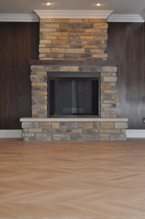 White oak floor against stone fireplace.