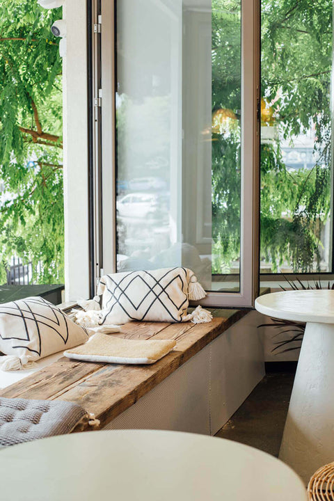 Cozy nook in restaurant with wood bench seat finished with oil wood finish.